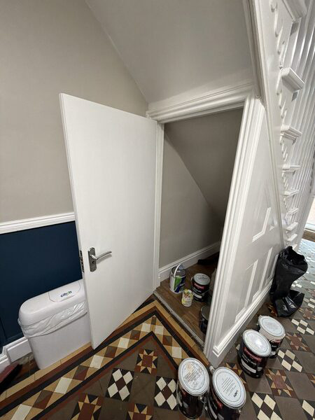 An open fire door showing the door edge and frame in a hallway