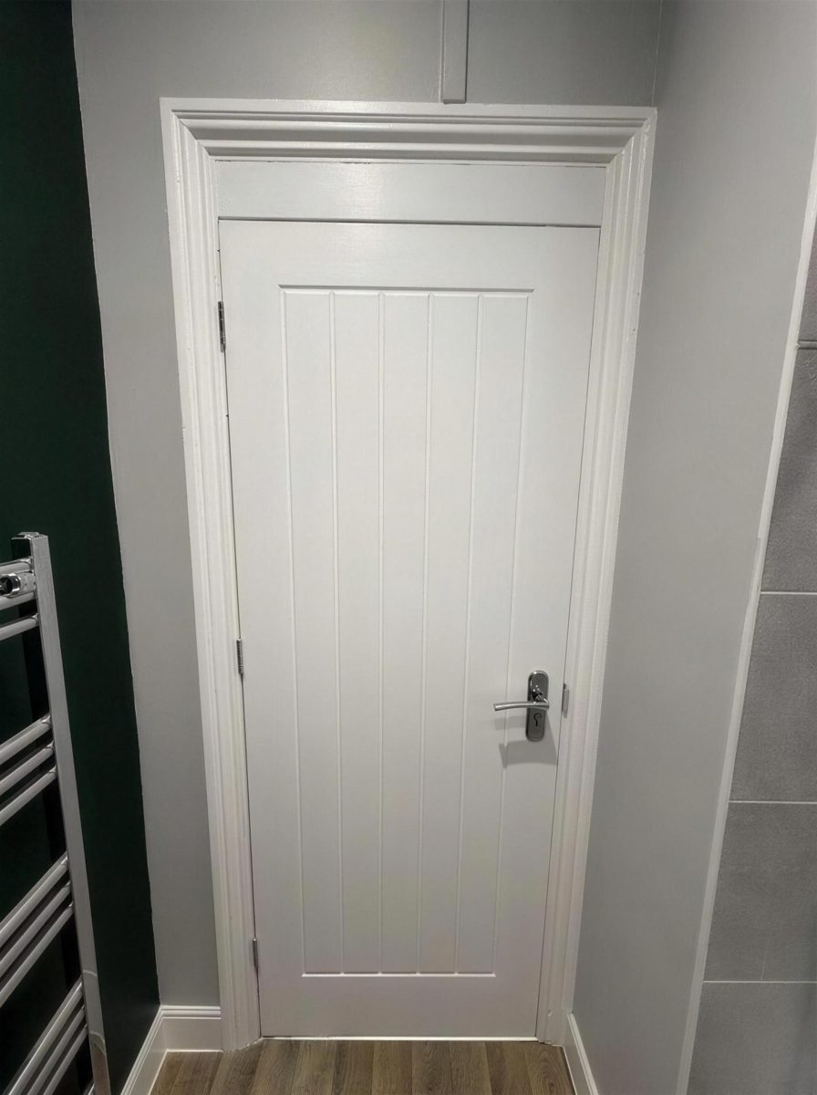 Fire door in a hallway with a dark green wall