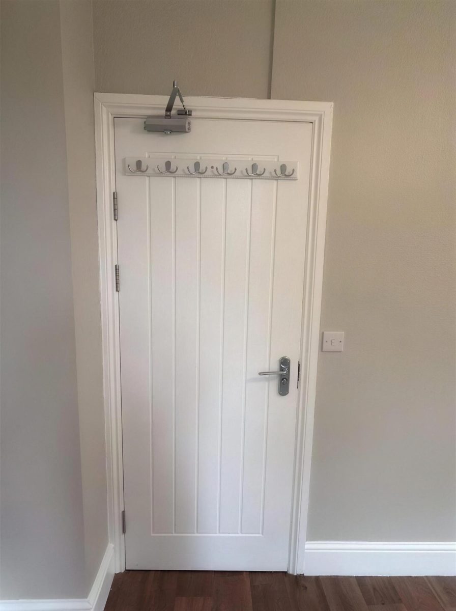 Panelled fire door in a shared house hallway