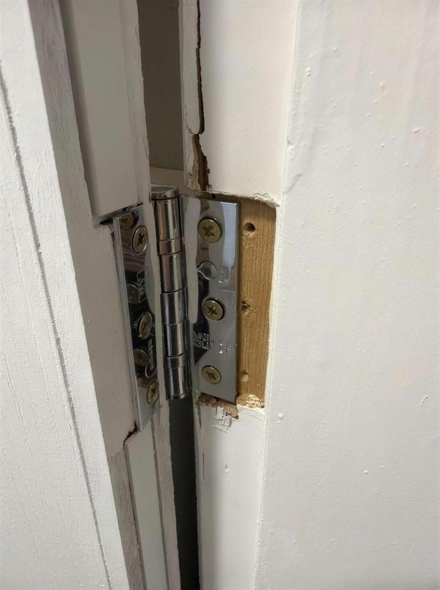 Hinge and gap between a fire door and its frame